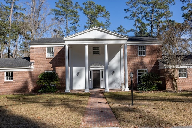 greek revival house with a front yard