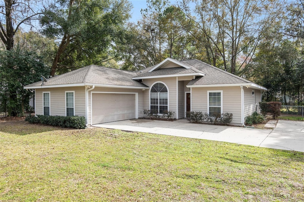 single story home with a garage and a front yard