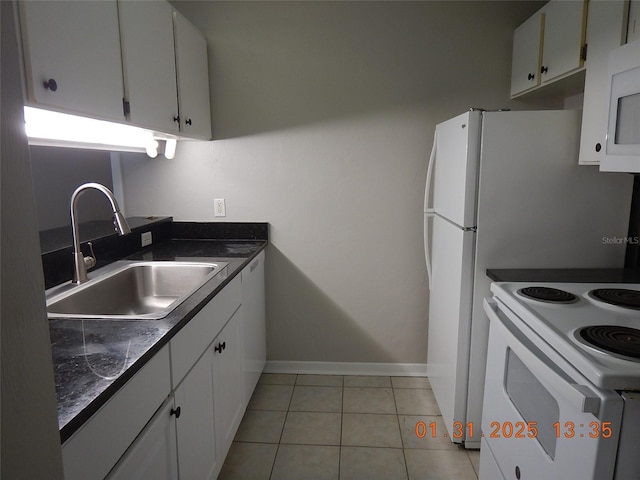 kitchen with white appliances, light tile patterned floors, sink, and white cabinets