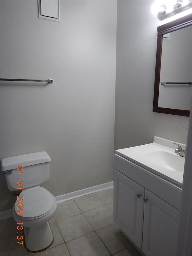 bathroom featuring vanity, tile patterned floors, and toilet