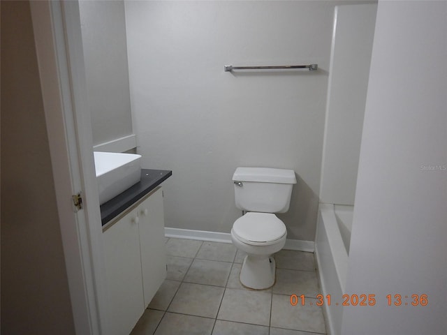 bathroom featuring vanity, tile patterned floors, and toilet