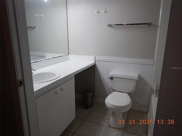 bathroom with tile patterned floors, vanity, and toilet