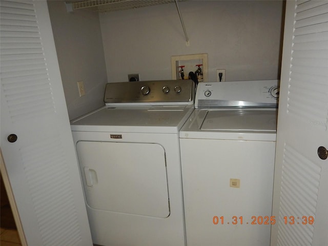 clothes washing area with washing machine and clothes dryer