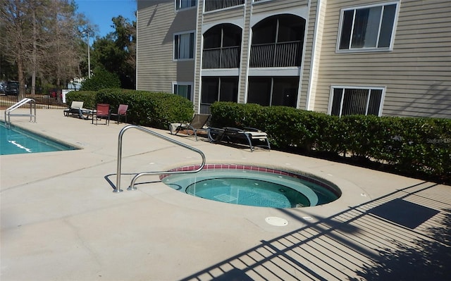 view of pool featuring an in ground hot tub and a patio