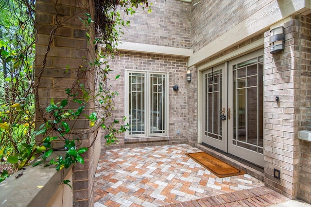 entrance to property featuring french doors and a patio area