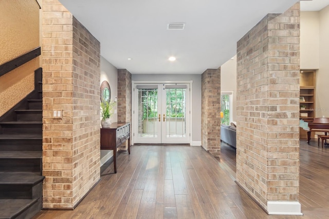 foyer featuring dark hardwood / wood-style flooring and french doors