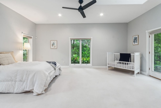 carpeted bedroom featuring access to exterior and ceiling fan