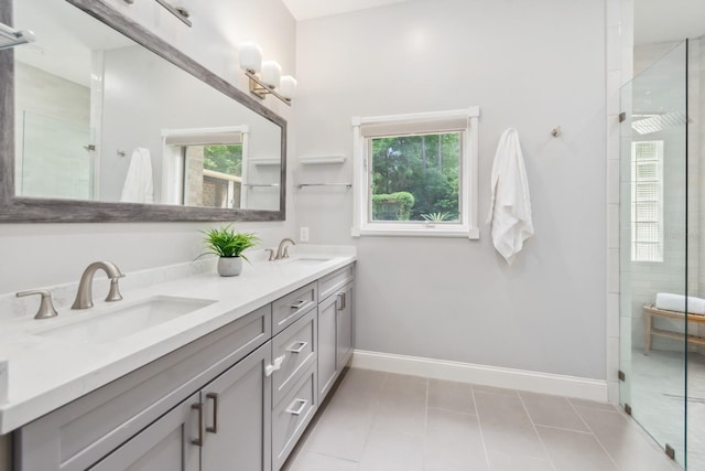 bathroom with walk in shower, vanity, and tile patterned flooring