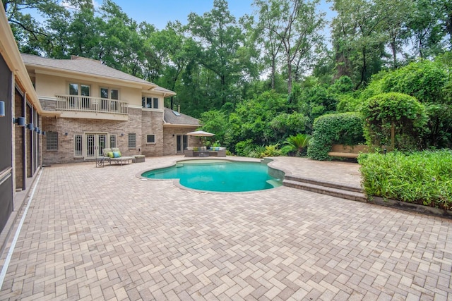 view of pool with a patio and french doors