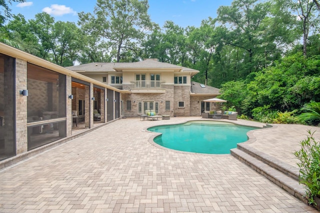 view of pool with an outdoor living space and a patio