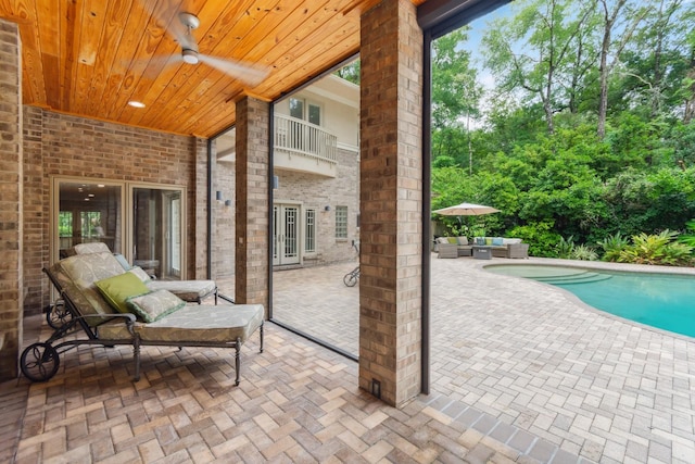 view of patio featuring a balcony, an outdoor hangout area, and ceiling fan