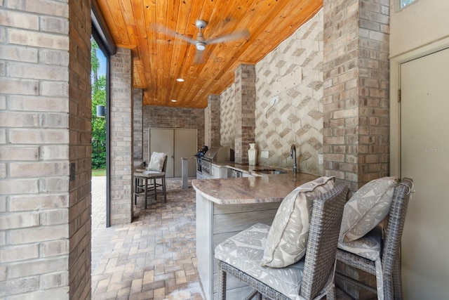 view of patio featuring sink, grilling area, ceiling fan, and an outdoor kitchen