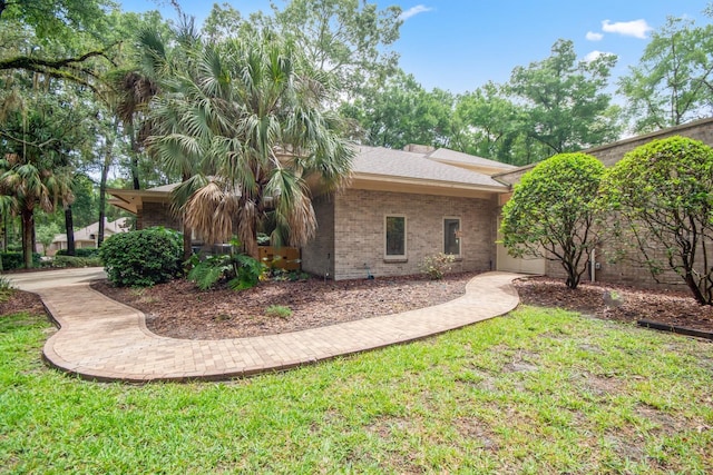 view of side of home with a yard