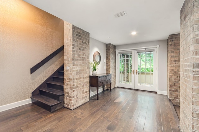 foyer featuring dark hardwood / wood-style floors and french doors