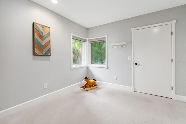 unfurnished room with light colored carpet