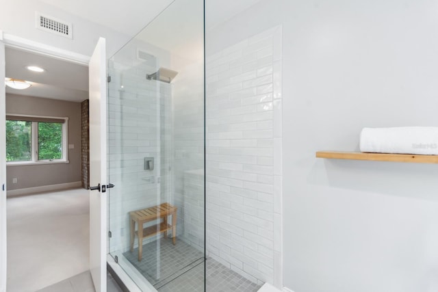 bathroom with a shower with shower door