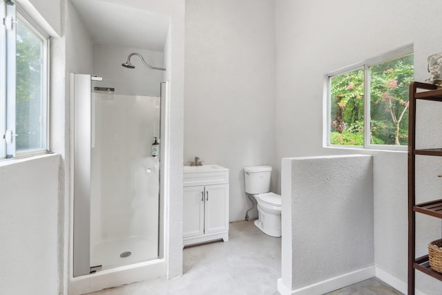 bathroom with vanity, a shower with shower door, concrete floors, and toilet