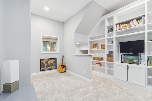 interior space featuring lofted ceiling and light carpet