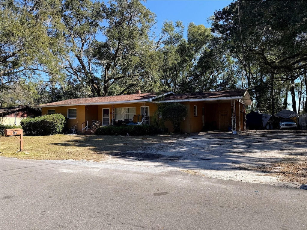 ranch-style house featuring a carport