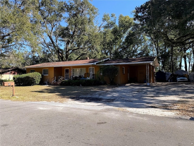 ranch-style house featuring a carport