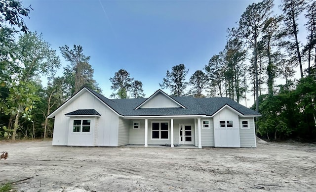 21179 NE 115th Pl, Waldo, FL 32694 - view of front facade featuring board and batten siding, a porch, and a shingled roof