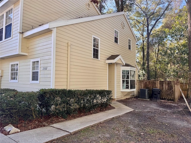 view of side of home featuring central AC