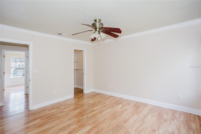 empty room featuring crown molding, ceiling fan, and light hardwood / wood-style flooring