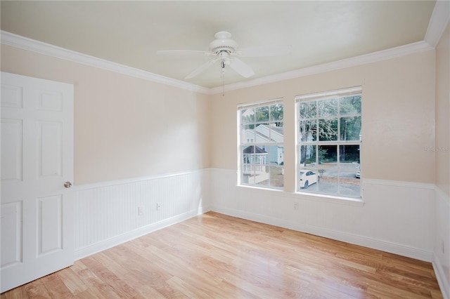 empty room with crown molding, ceiling fan, and light hardwood / wood-style flooring