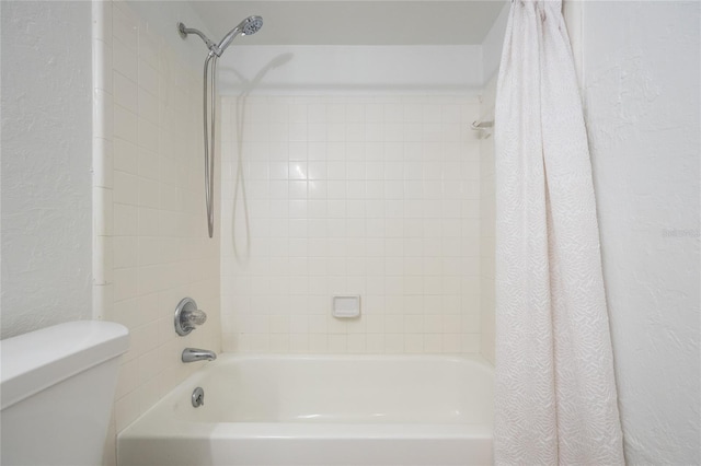 bathroom featuring toilet and shower / bath combo with shower curtain