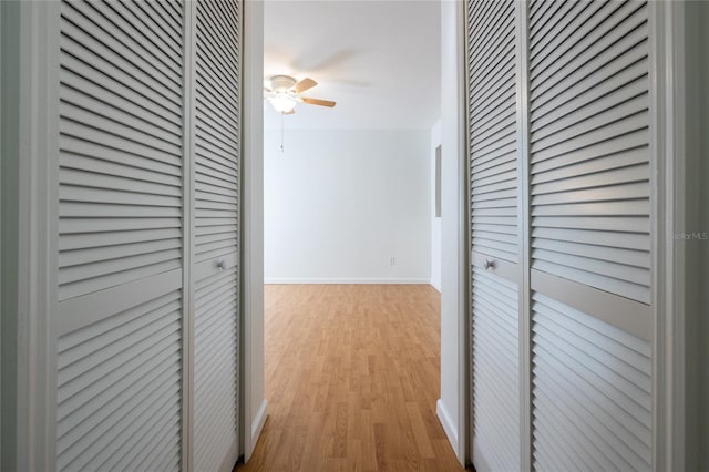 hallway with light hardwood / wood-style floors