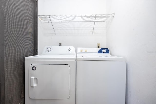 clothes washing area featuring independent washer and dryer