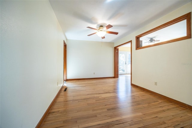 empty room featuring light hardwood / wood-style flooring and ceiling fan