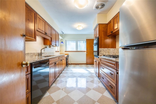 kitchen with tasteful backsplash, sink, light stone counters, and black appliances