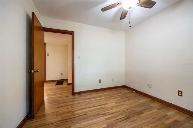 spare room featuring ceiling fan and light hardwood / wood-style flooring