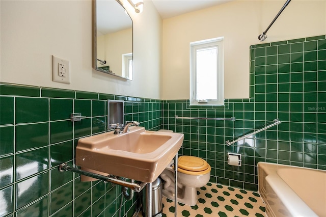 full bathroom featuring tile walls, sink, shower / tub combination, and toilet