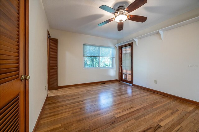 unfurnished bedroom with ceiling fan, access to exterior, and light hardwood / wood-style floors