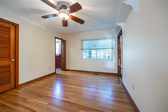 unfurnished bedroom with ceiling fan and light hardwood / wood-style flooring