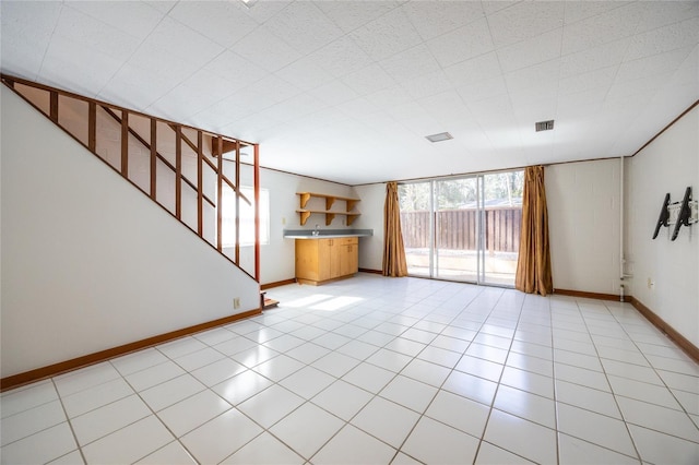 unfurnished living room featuring light tile patterned flooring