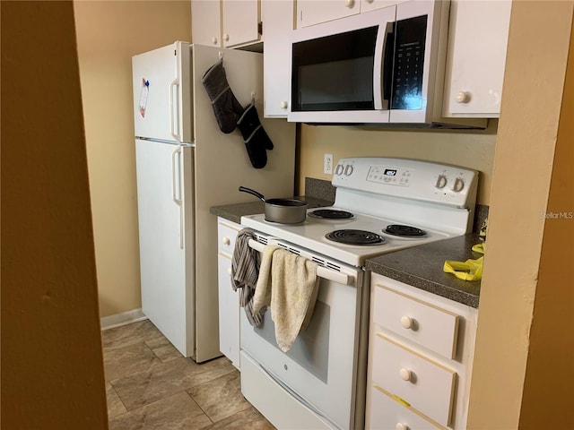 kitchen featuring white cabinetry and white appliances