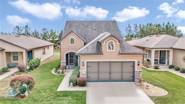 view of front facade featuring a garage and a front lawn