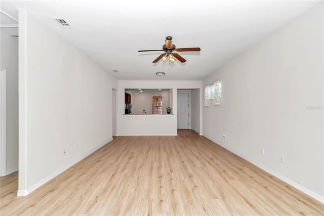 unfurnished living room featuring ceiling fan and light hardwood / wood-style floors