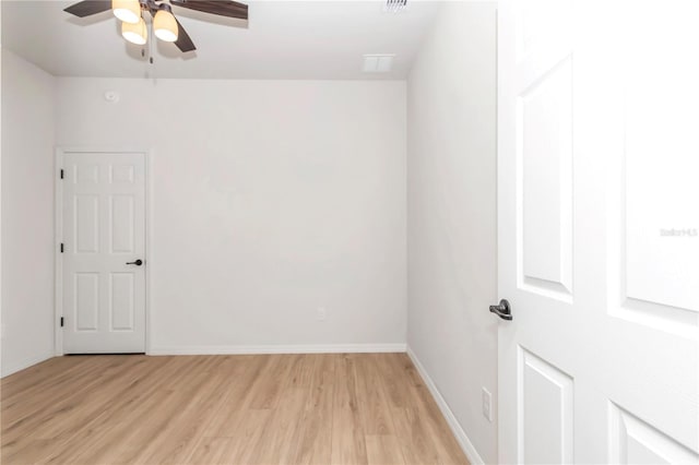 unfurnished room with ceiling fan and light wood-type flooring