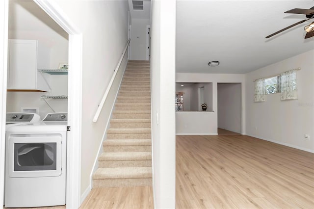 staircase featuring hardwood / wood-style flooring, washer and clothes dryer, and ceiling fan