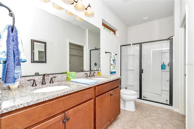 bathroom with walk in shower, vanity, toilet, and tile patterned flooring