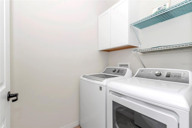 laundry room featuring independent washer and dryer and cabinets