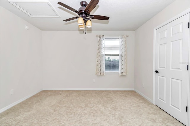 carpeted empty room featuring ceiling fan