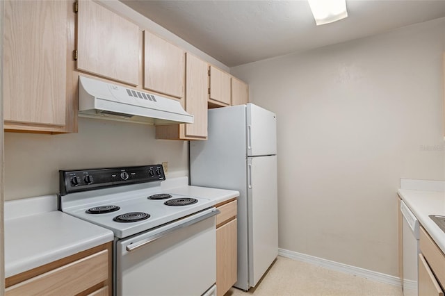 kitchen with white appliances and light brown cabinets