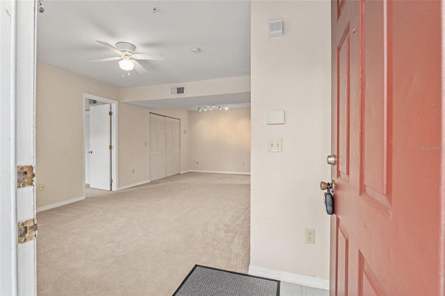 carpeted entrance foyer featuring ceiling fan