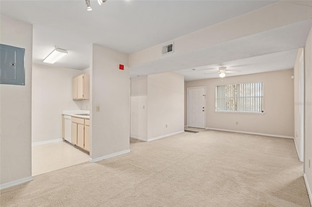 carpeted empty room featuring ceiling fan and electric panel