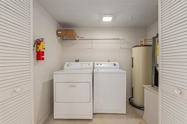 washroom with electric water heater and independent washer and dryer